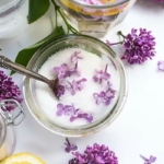 Lilac flowers and lilac sugar in a bowl.