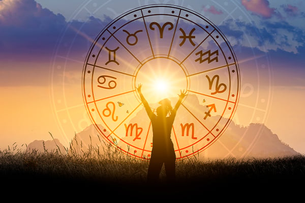 A woman reaching toward a zodiac wheel centered upon the Sun.